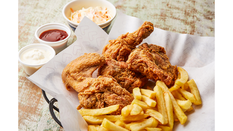 chicken broasted with french fries, chili sauce and mayo dip served in dish isolated on table top view of arabic food