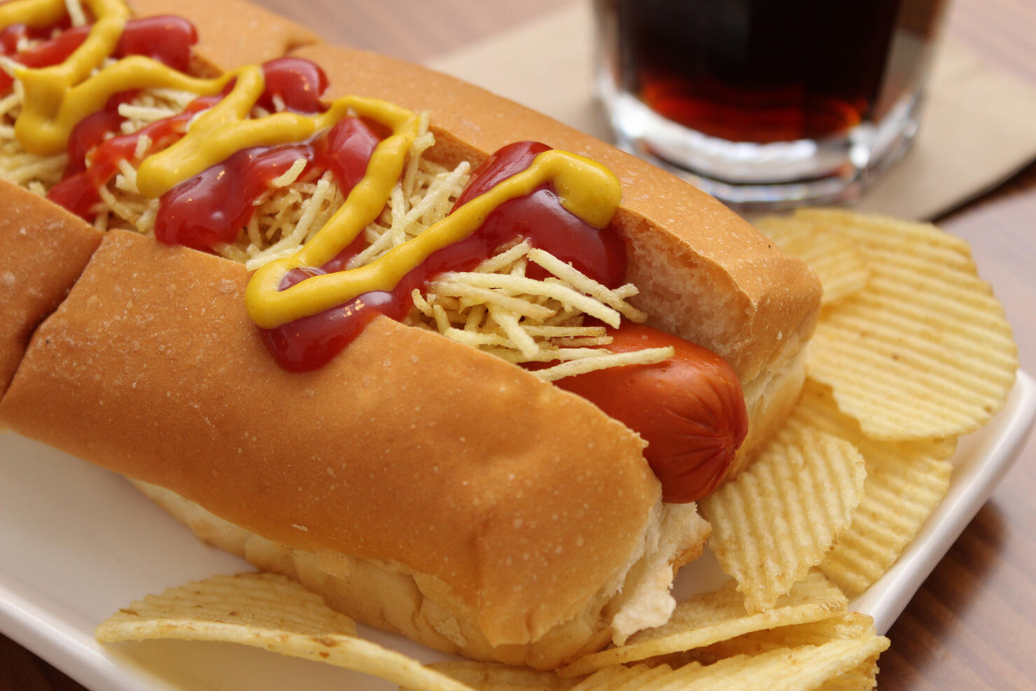 Delicious hot dog with ketchup, mustard and chips