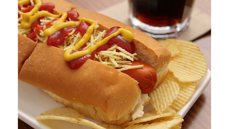 Delicious hot dog with ketchup, mustard and chips