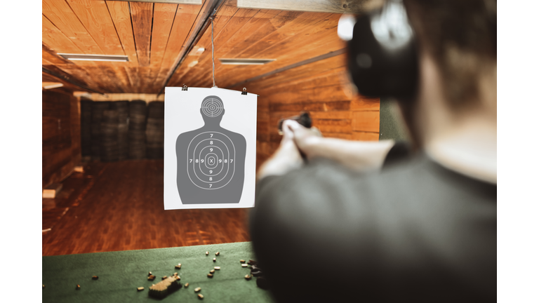 Focused Male Trying To Score High On Gun Practicing Range