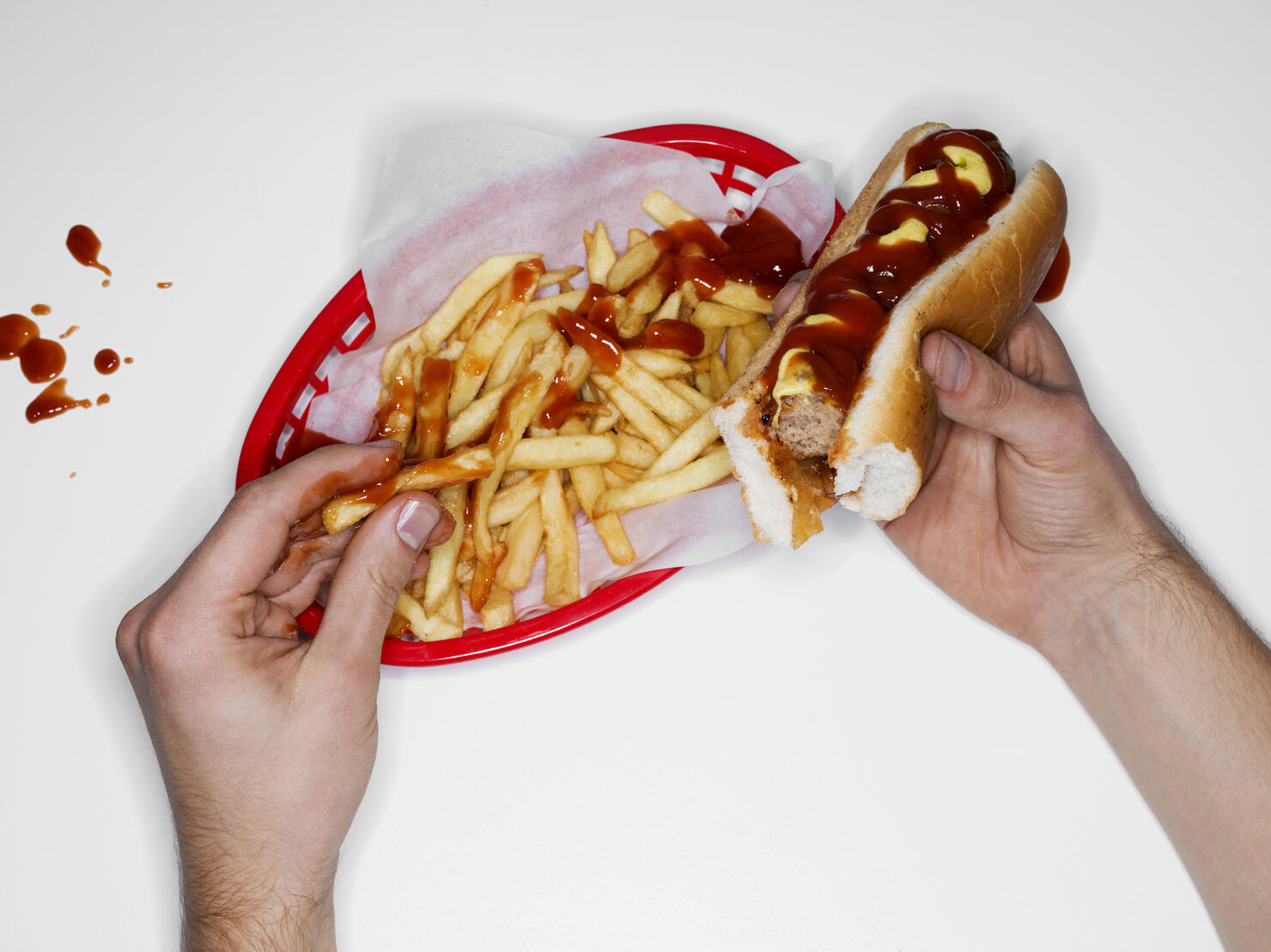 Messy eating, hot dog and fries, overhead view