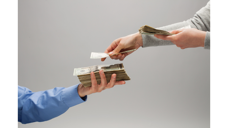 Woman handing man money