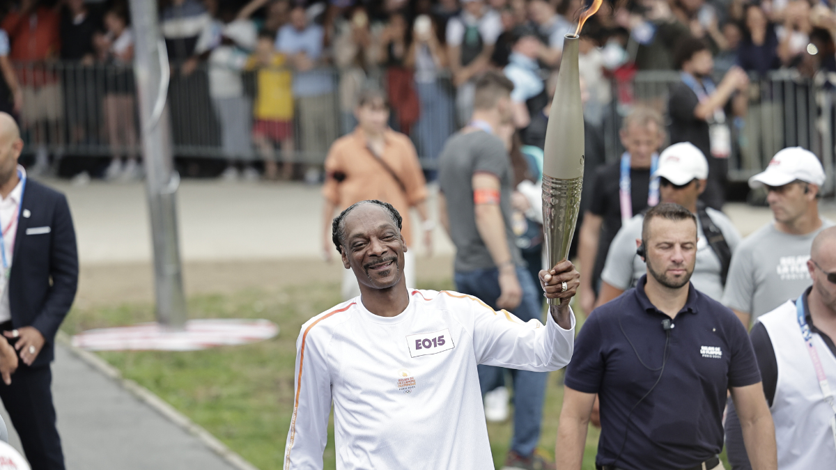 Snoop Dogg Carries Olympic Torch In Paris Ahead Of Opening Ceremony