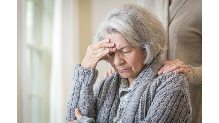 Close up of daughter comforting pained mother
