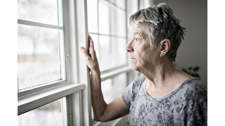 A sad lonely 70 years old senior in is apartment