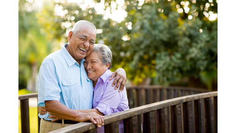 Mexican senior couple laughing on bridge