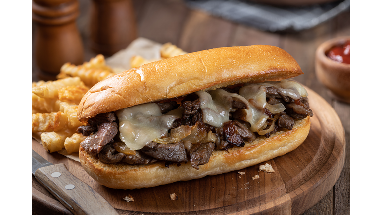 Philly cheesesteak sandwich and french fries