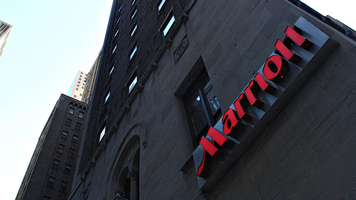 A Marriott logo hangs on the side of a hotel in New York Thu