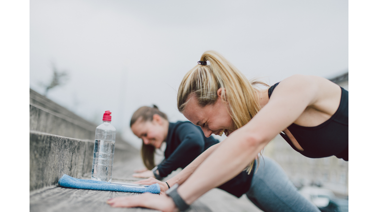 Girlfriends doing push-ups together