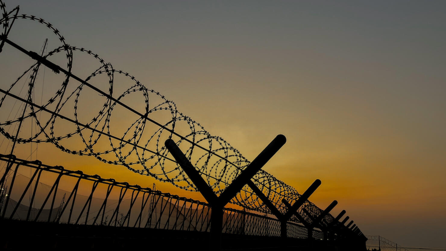 Barbed Wire Against Sunset Sky Background