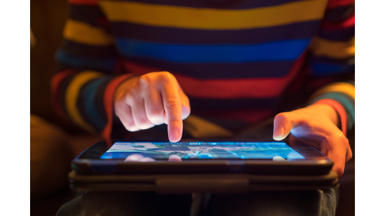 Close up of a young boy using a tablet computer