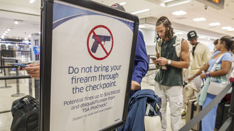 Miami, Florida, Miami International Airport, TSA checkpoint security screening, warning sign, do not bring firearms or weapons