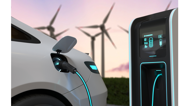 Electric cars Charging at the charging station and with a Wind turbine background, Electric power is an alternative fuel