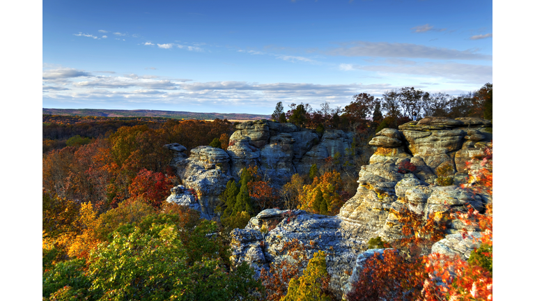 Rock formations surrounded by trees with autumnal foliage on sunny day, Illinois, USA