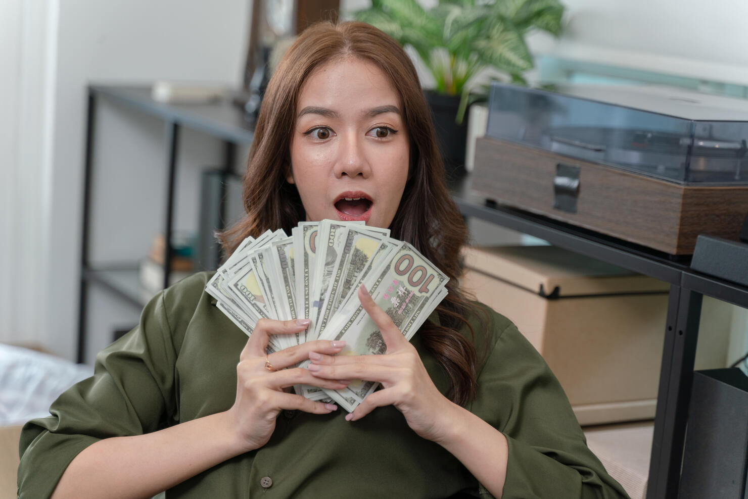 A woman is holding a bunch of money in her hands