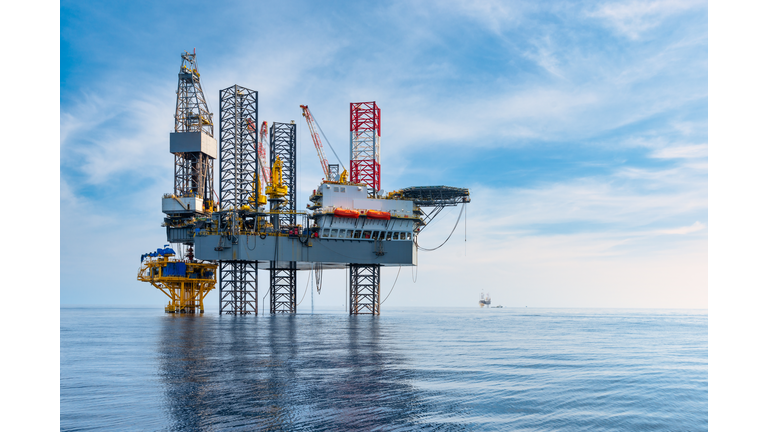 Oil rig type offshore Jack Up drilling rig in The Middle of The Sea drilling offshore well for oil and gas production industry.