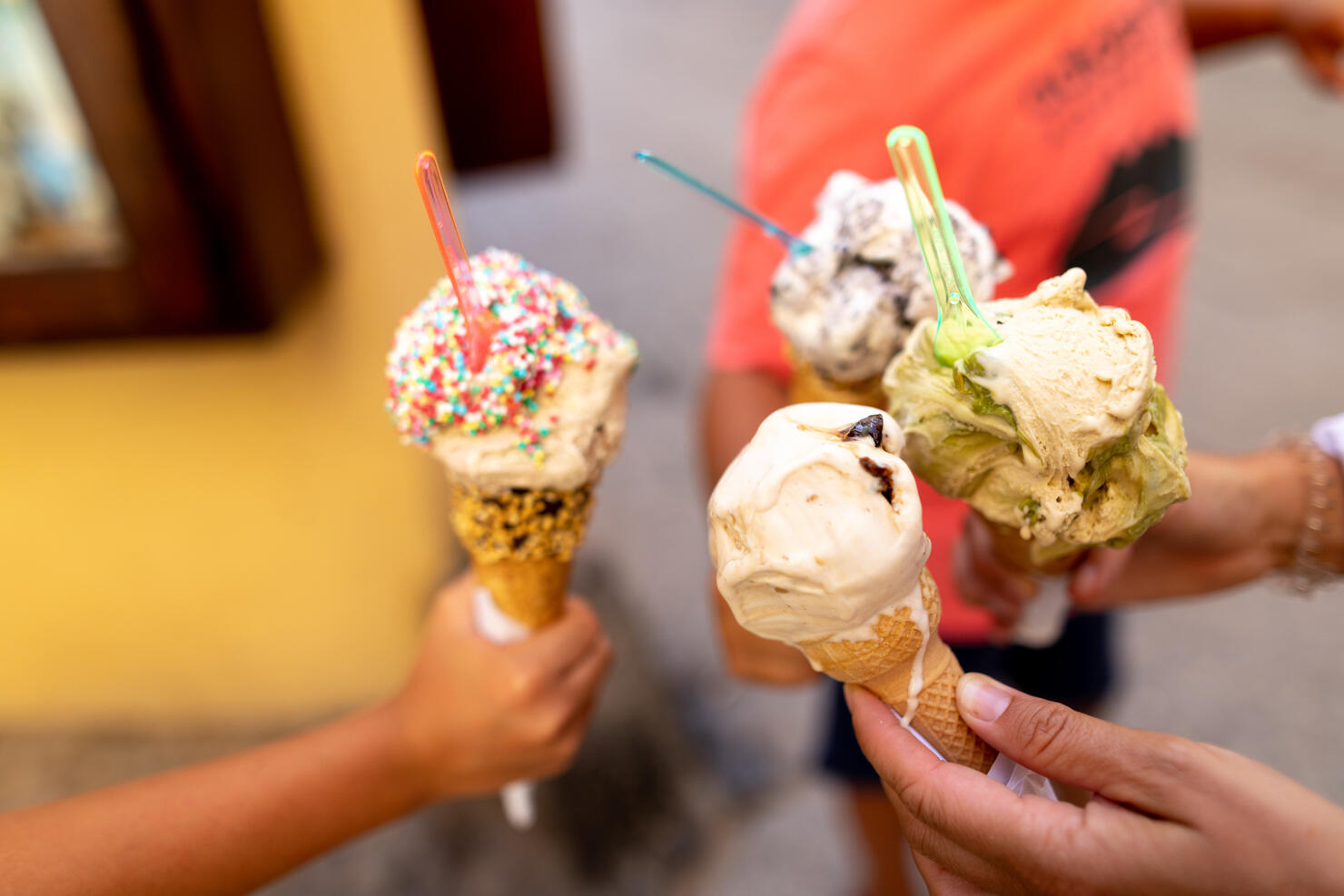 Very appetizing ice cream in the hands of people.