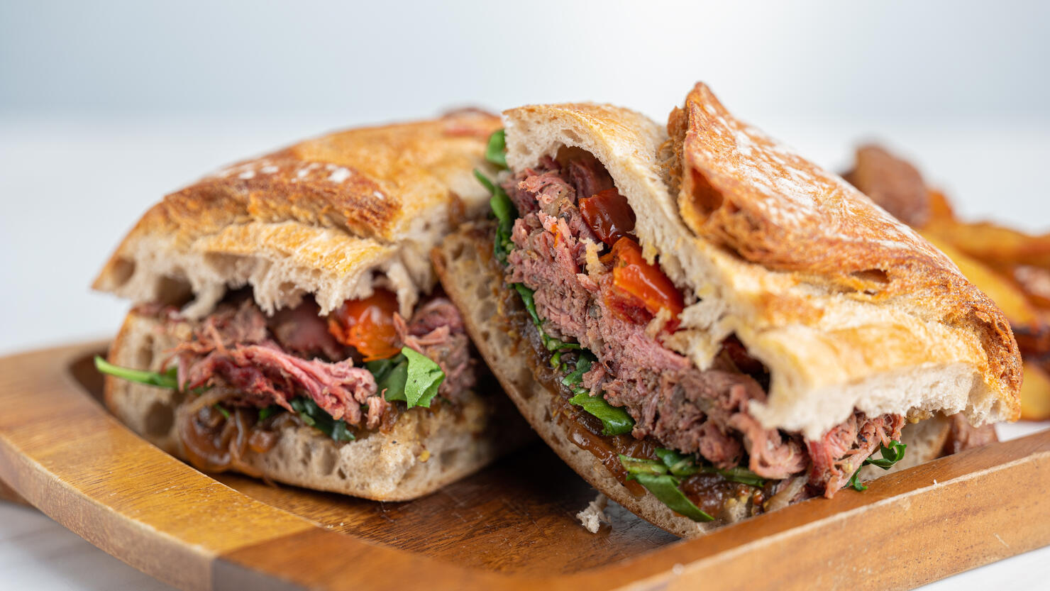 Beef Sandwich with Potato Wedges on Wooden Board