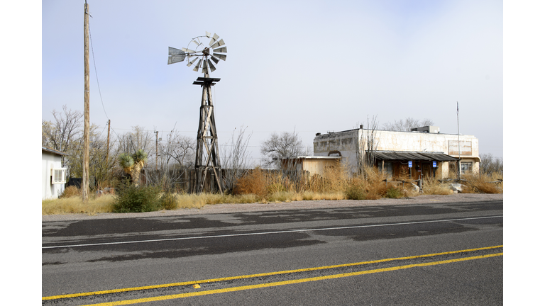 Abandoned building and traditional windmill at Sierra Blanca, Texas, USA