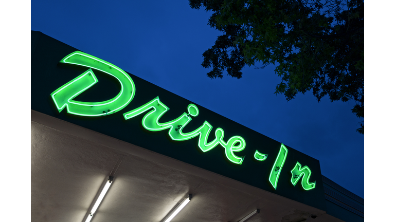 Neon drive in sign at dusk