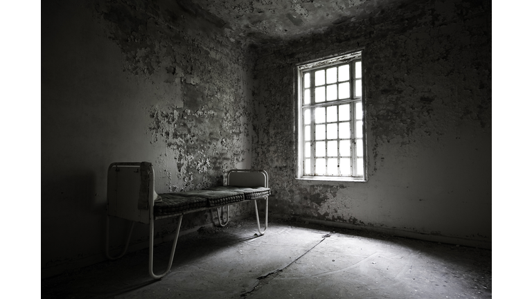 Abandoned hospital with a bed in the corner