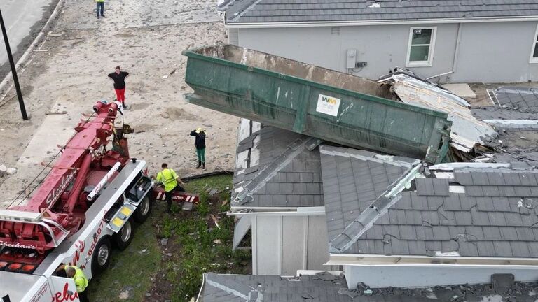 Dumpster On Roof Of Home In Avenir