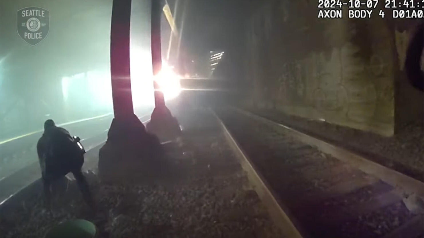 Cops rescue a man on train tracks