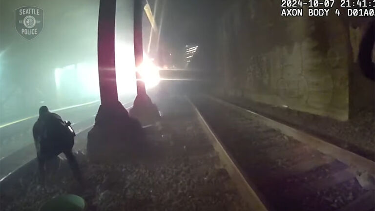 Cops rescue a man on train tracks