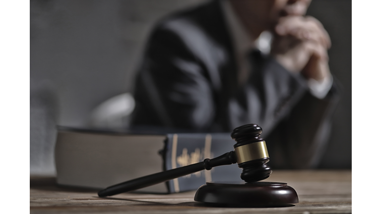 Gavel and law book in front of lawyer