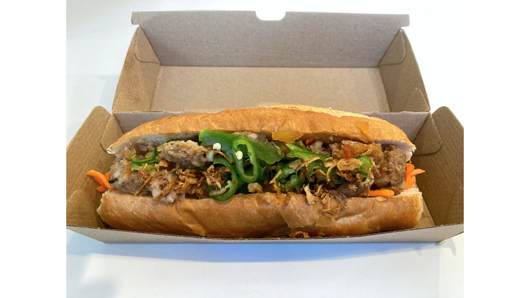 Pork meatball banh mi sandwich in a cardboard takeout box