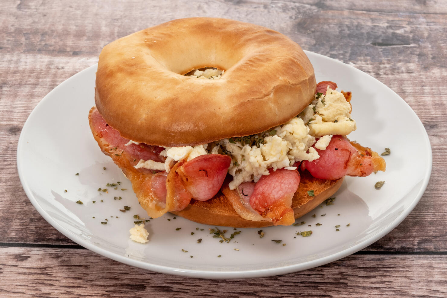 Fresh bagel with grilled bacon and scrambled egg