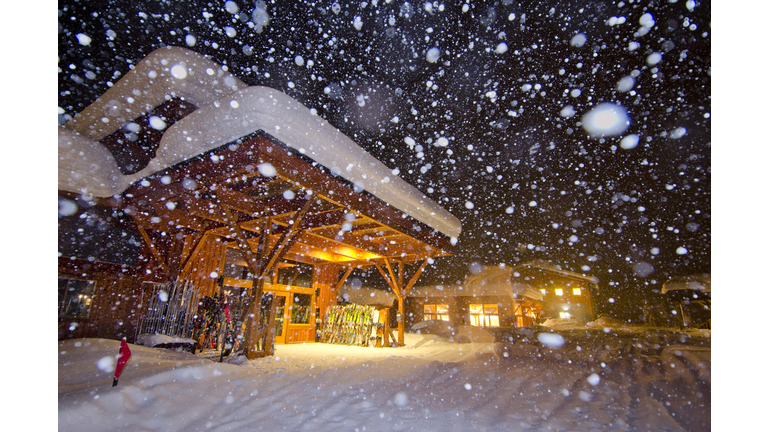 Ski lodge in heavy snowfall at night.
