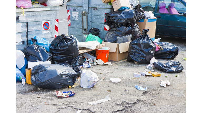 Overflowing garbage bins in a urban road