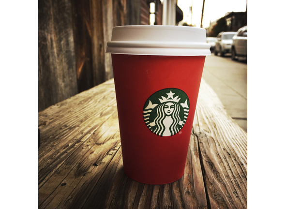 Red Starbucks Coffee Cup on Wooden Bench