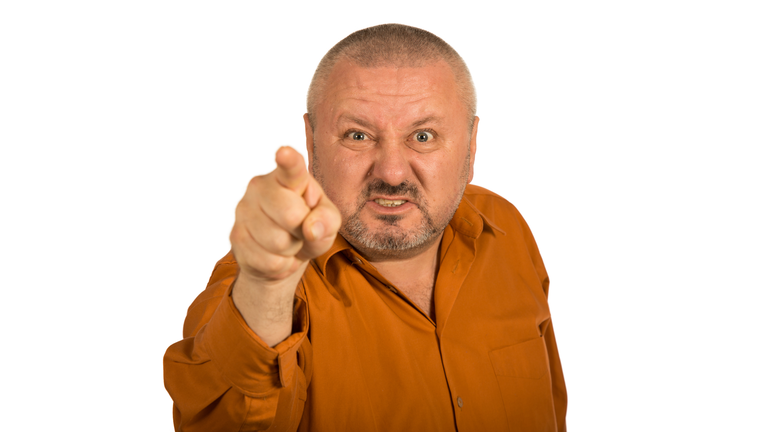 An angry man with beard pointing finger at you