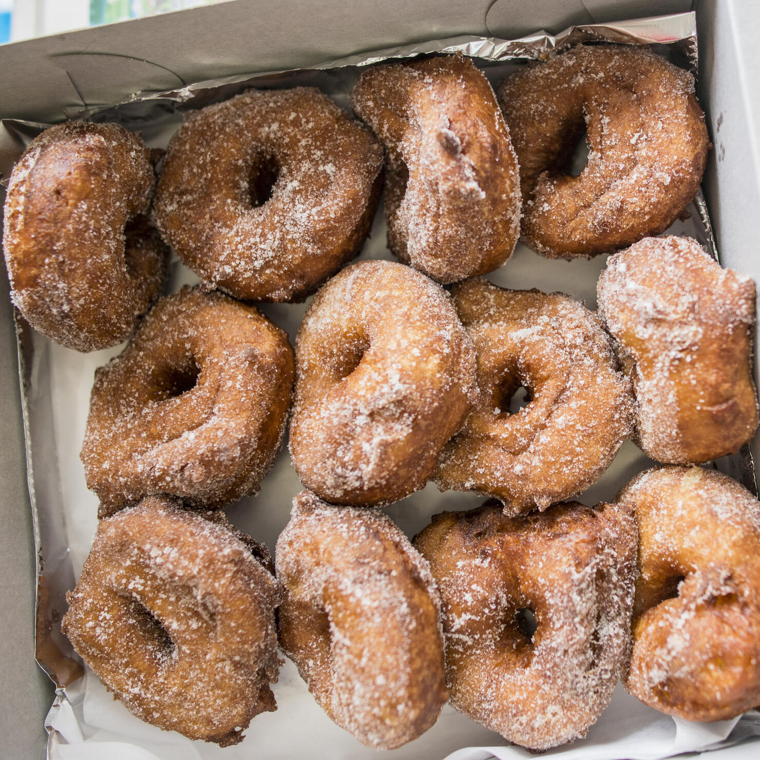 Close up of a boxful of malasadas (portuguese donuts), Hawaii, USA