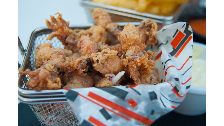 Fried squids in a small metal basket