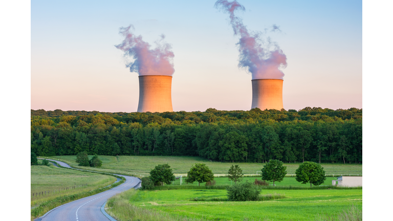 Steaming Cooling Towers at Nuclear Power Plant around Sunset