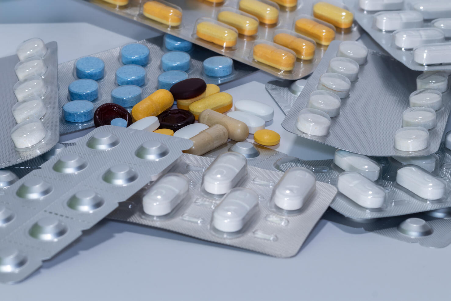 Multicolored pills scattered on white
Assorted pills in vibrant colors