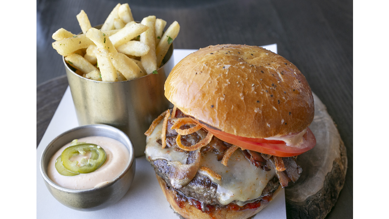 Gourmet Cheese and bacon burger with gherkin and fries