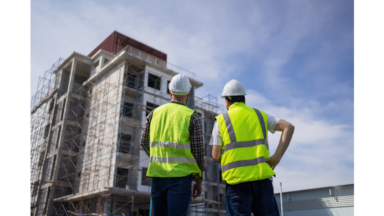 The engineers in the workplace are inspecting the specifications of buildings, apartments, and residences.