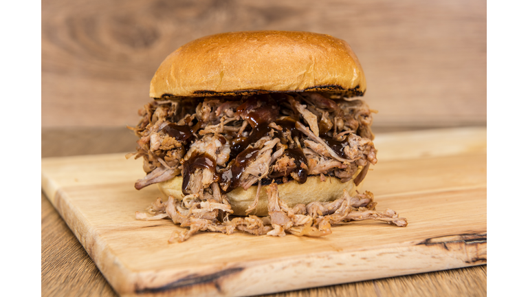 BBQ pulled pork sandwich on a wooden background