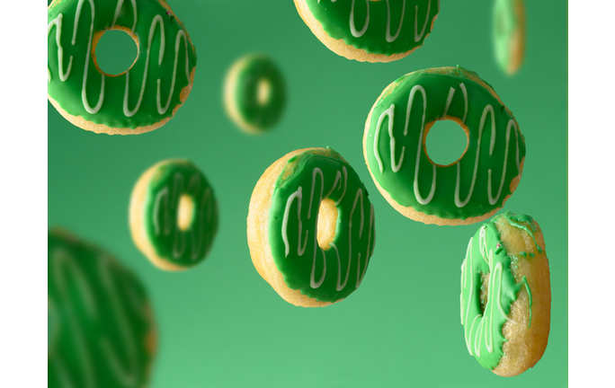 sweet green donuts levitate on a green background