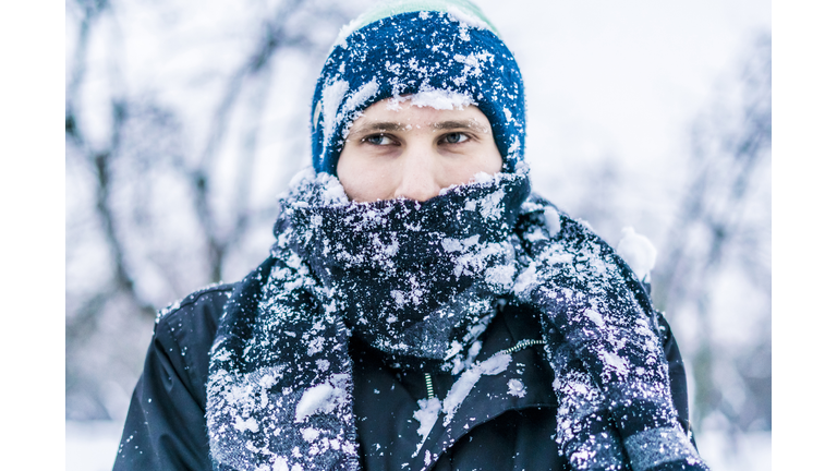 close up frost man's face with scarf covered by snow on a winter day f