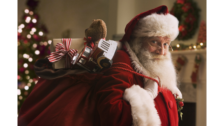 Santa Claus carrying sack of gifts, portrait, close-up