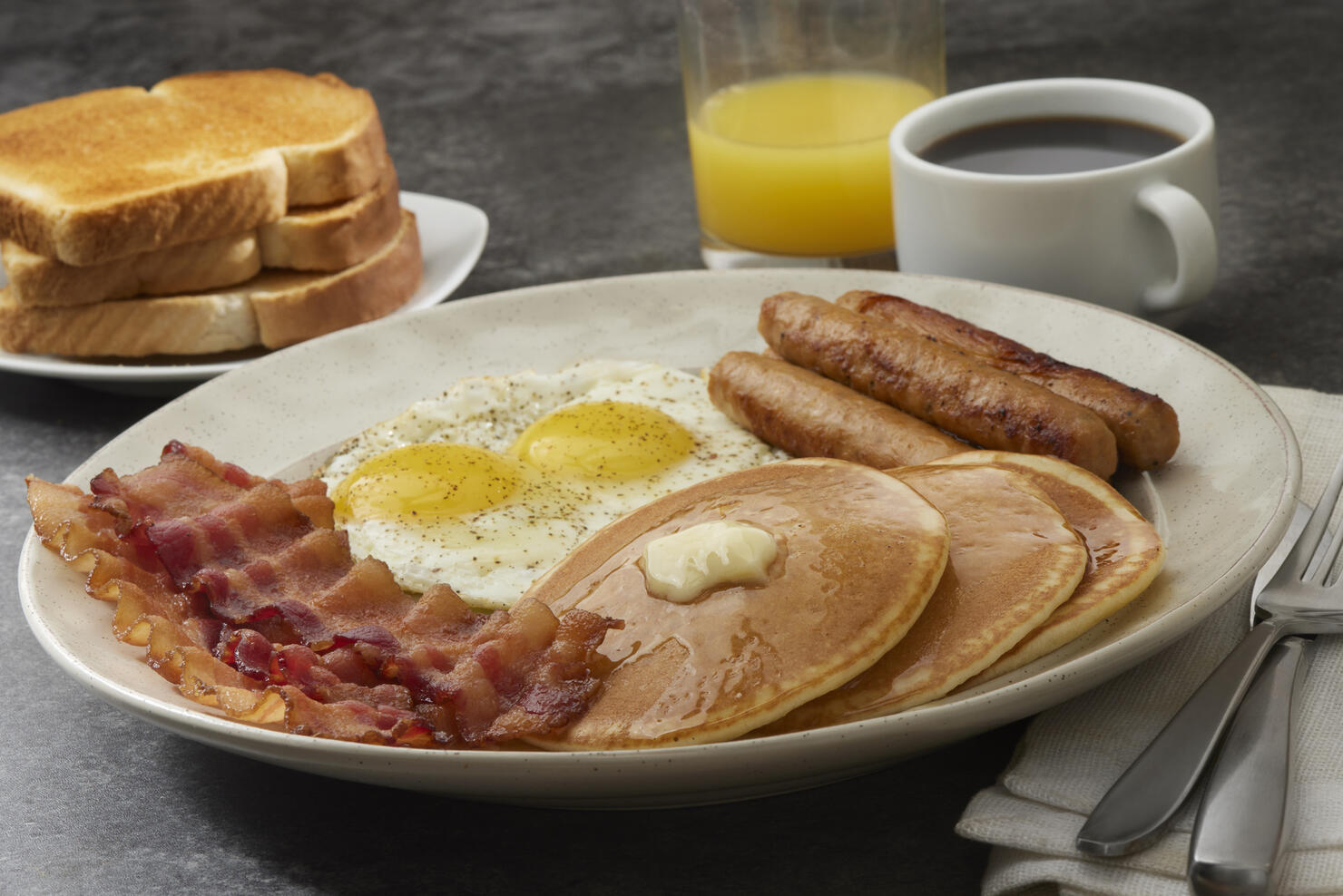Grand Slam Breakfast with Pancakes, Bacon, Eggs, and Toast
