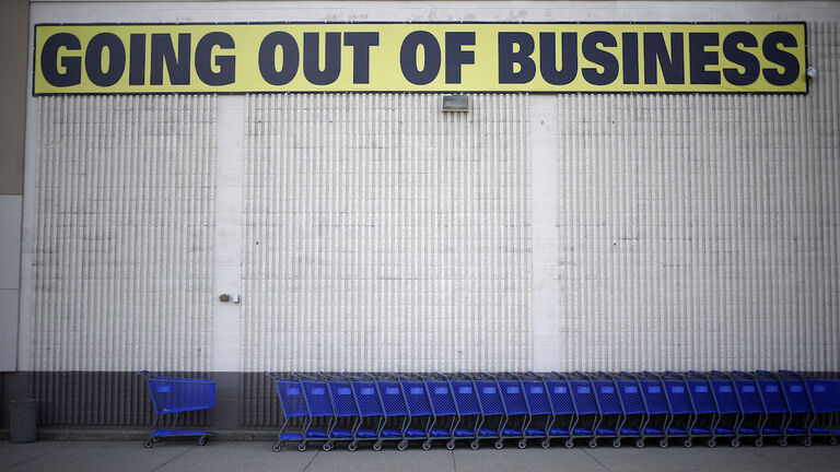 A "Going Out Of Business"sign is displayed outside a retail store