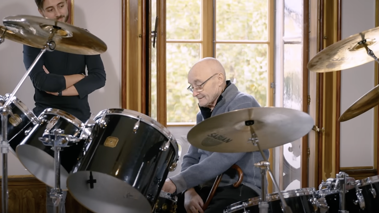 Watch Phil Collins Sit Behind Iconic Drum Kit For First Time In A