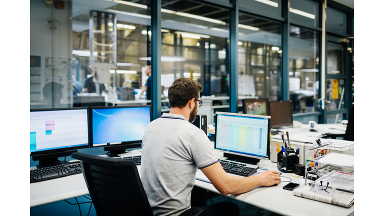 Engineer in control room of a factory