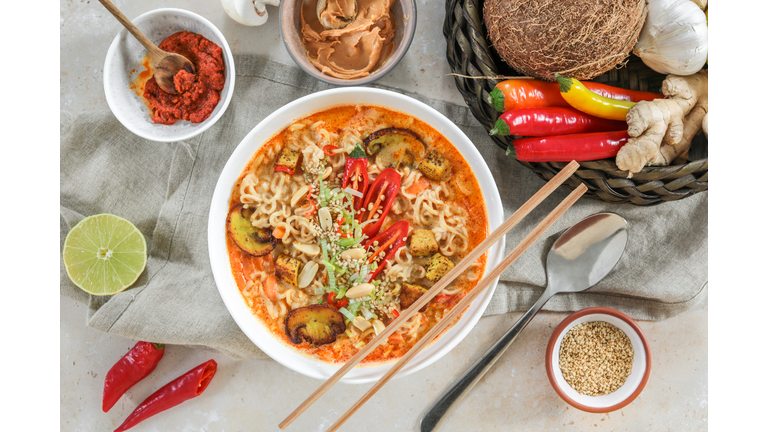 Asian Mie Noodle Soup with Tofu, Peanut, Lime and Chili as Flat Lay